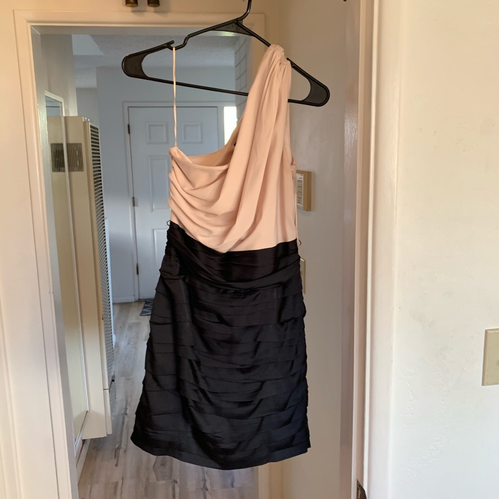 Express one sleeved, mid thigh length dress.